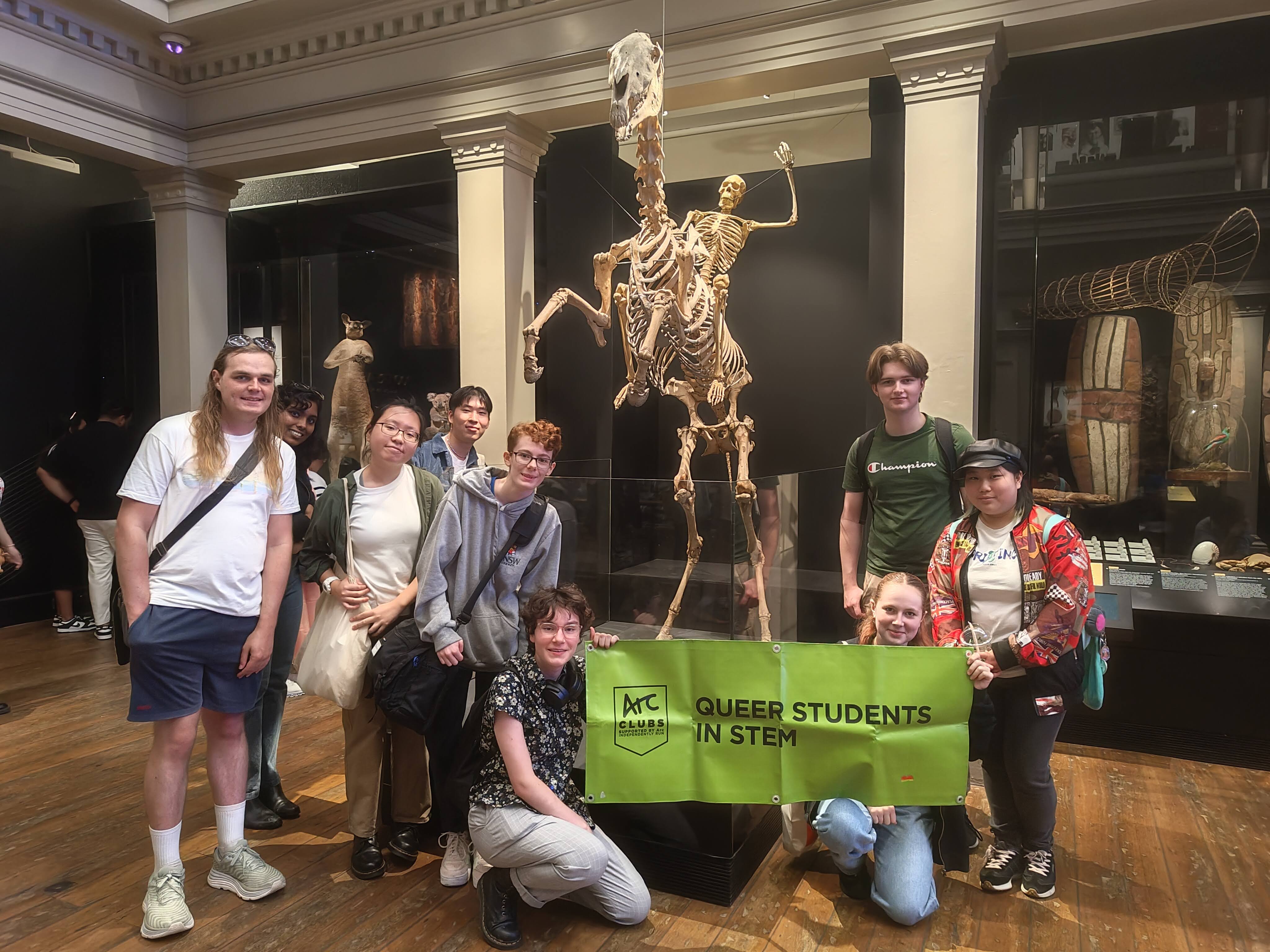 People standing in front of a skeleton riding a skeleton horse